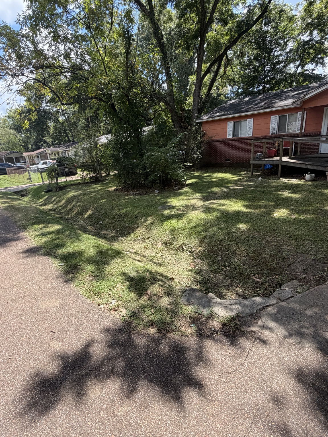 Trimmed roadside drainage ditch and maintained residential lawn in Brandon Mississippi