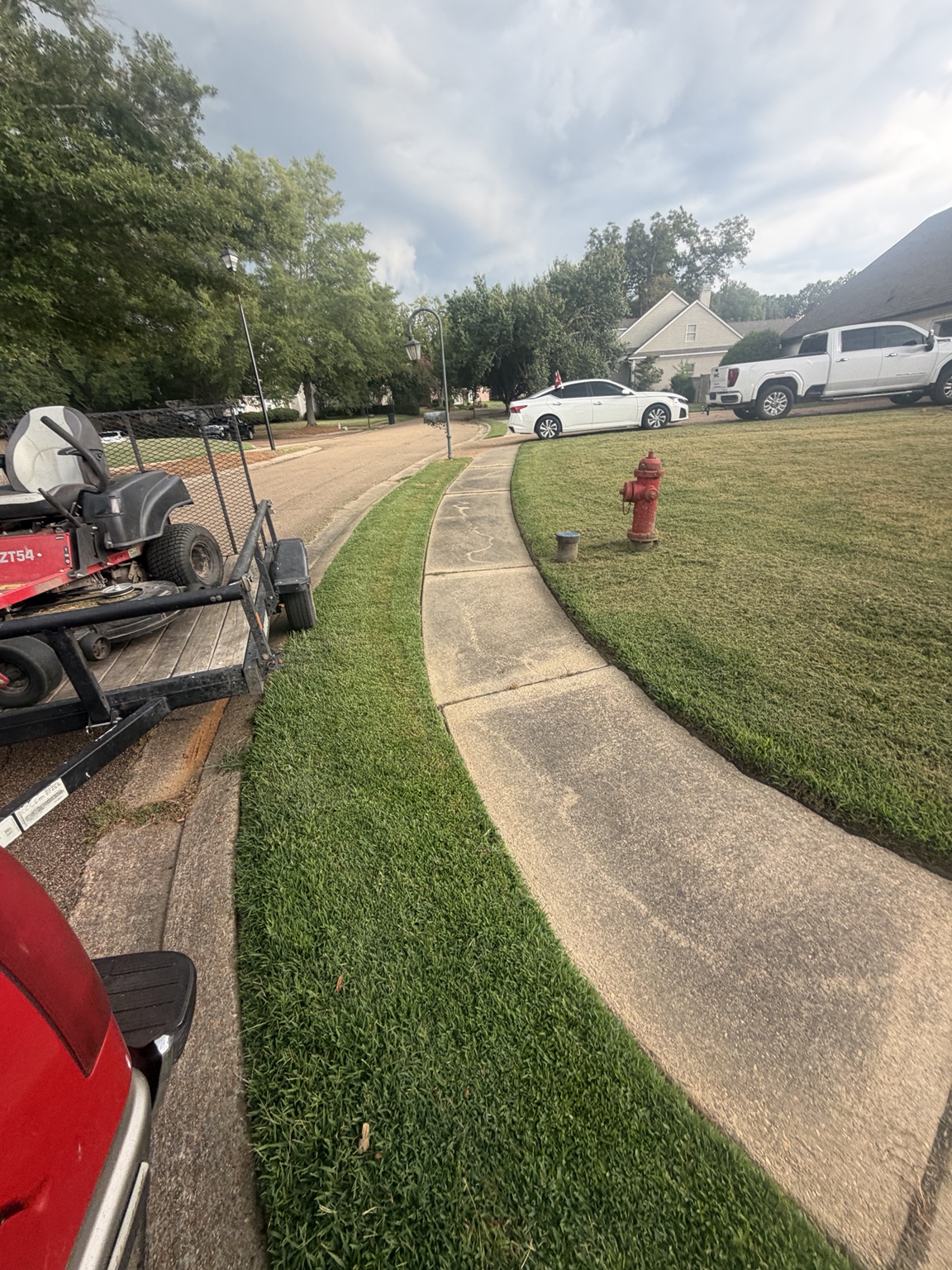 Finished walkway and crisp lawn borders after weekly lawn care in Madison Mississippi